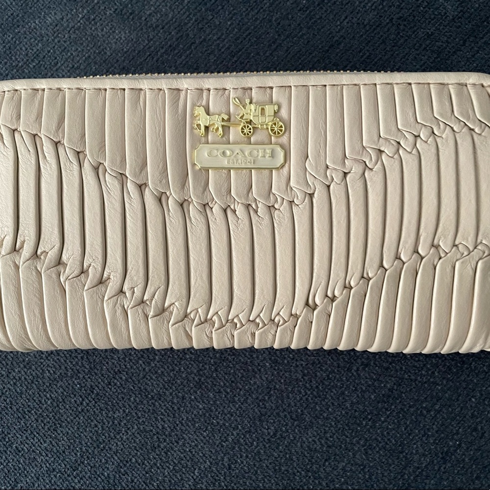 Brand new Coach accordion cream leather wallet.